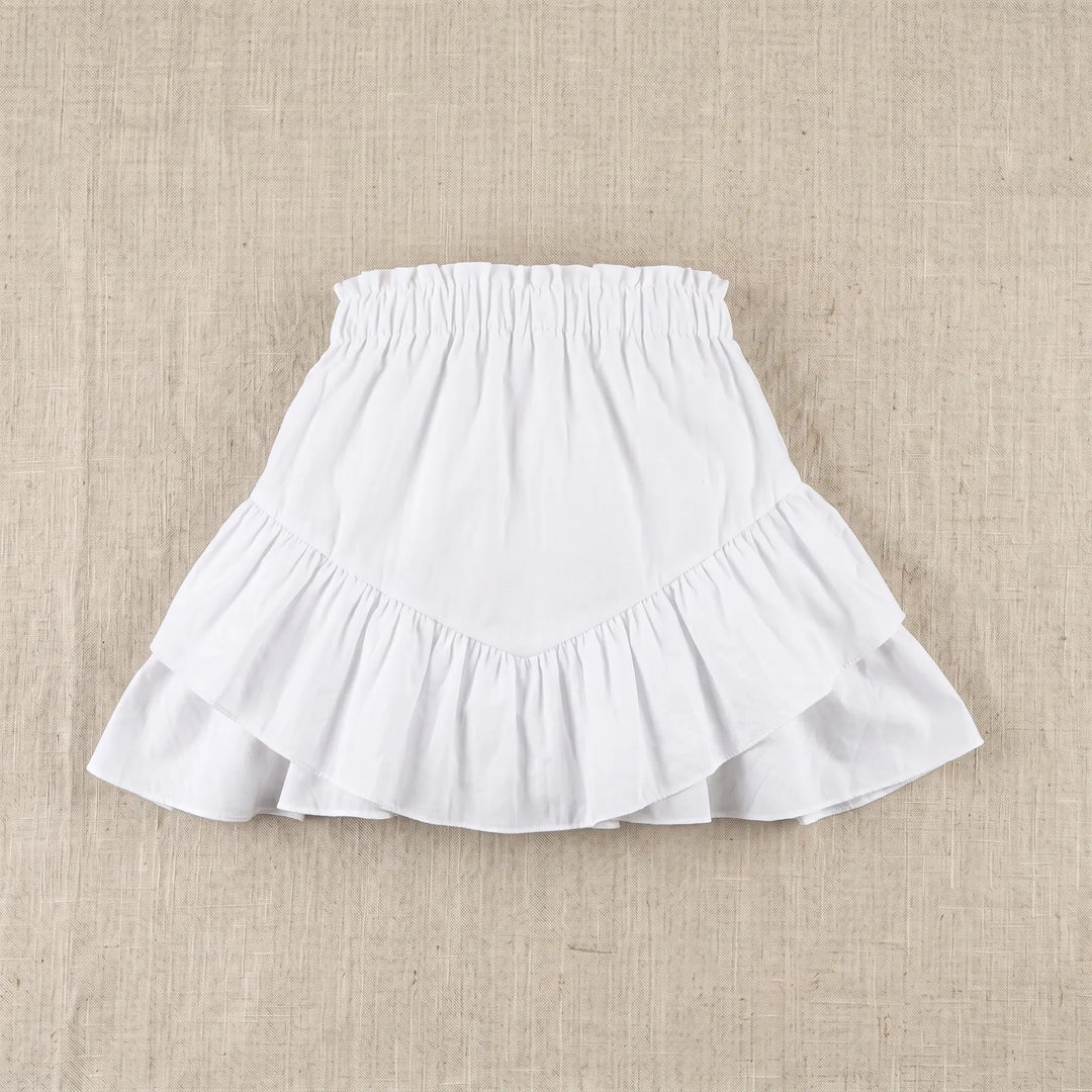 Elarae white mini skirt with tiered ruffles and an elasticated waistband, shown flat on a textured neutral background.