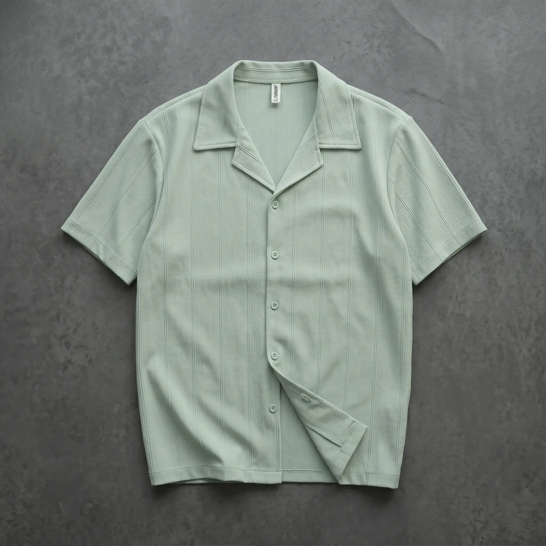 Pale mint green Kaelen short-sleeve Cuban collar shirt featuring subtle vertical ribbing and tonal matte buttons, laid flat from the front.