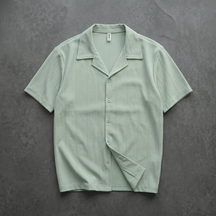 Pale mint green Kaelen short-sleeve Cuban collar shirt featuring subtle vertical ribbing and tonal matte buttons, laid flat from the front.